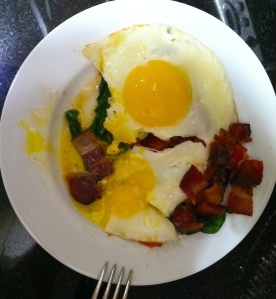 Sunny eggs over bacon, spinach & tomatoes